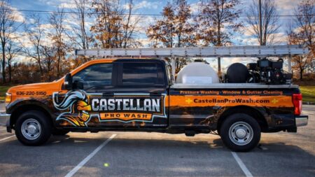 Pressure washing team truck providing window and gutter cleaning services.
